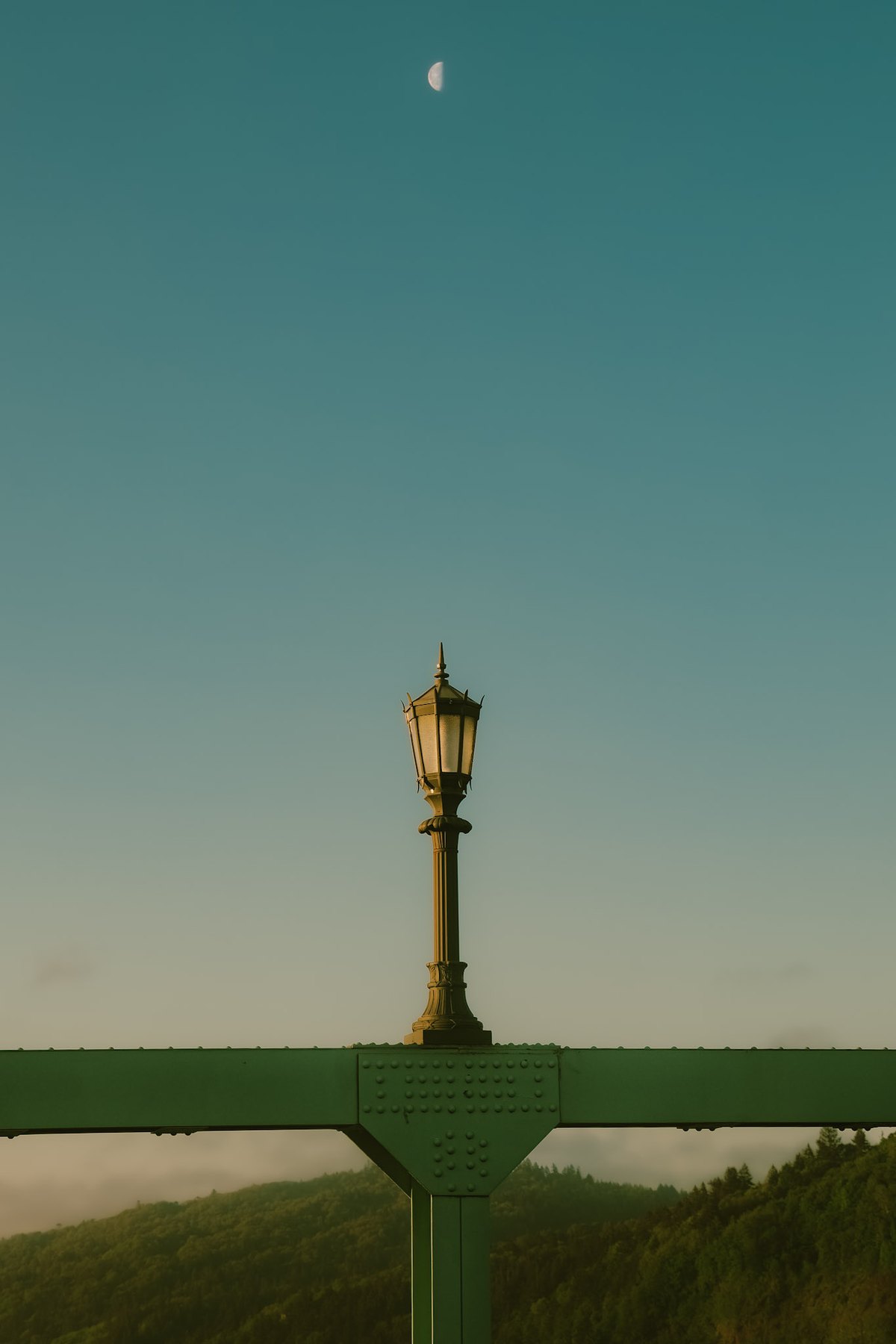 Streetlamp against sky with moon